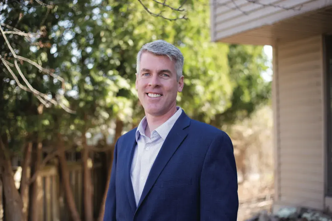 Jeff Haverdink smiling in front of trees