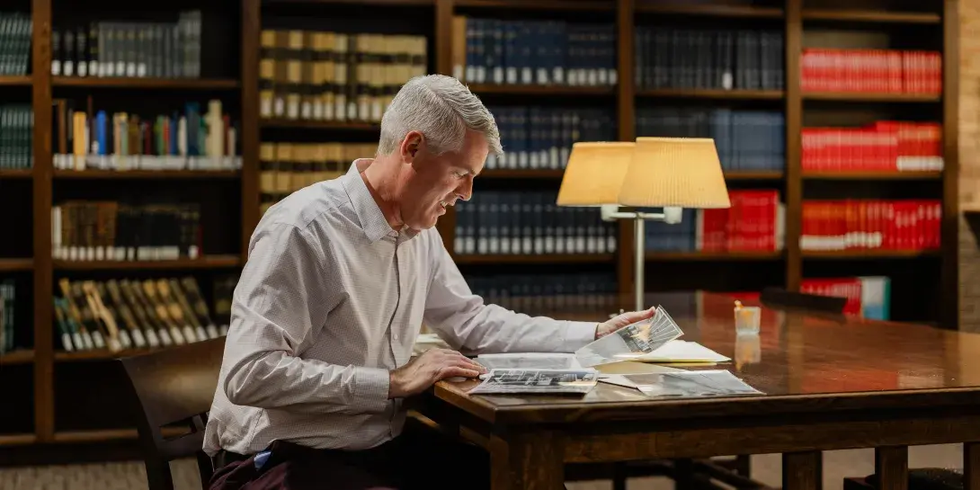 Jeff Haverdink reading publication in Heritage Hall at Calvin University