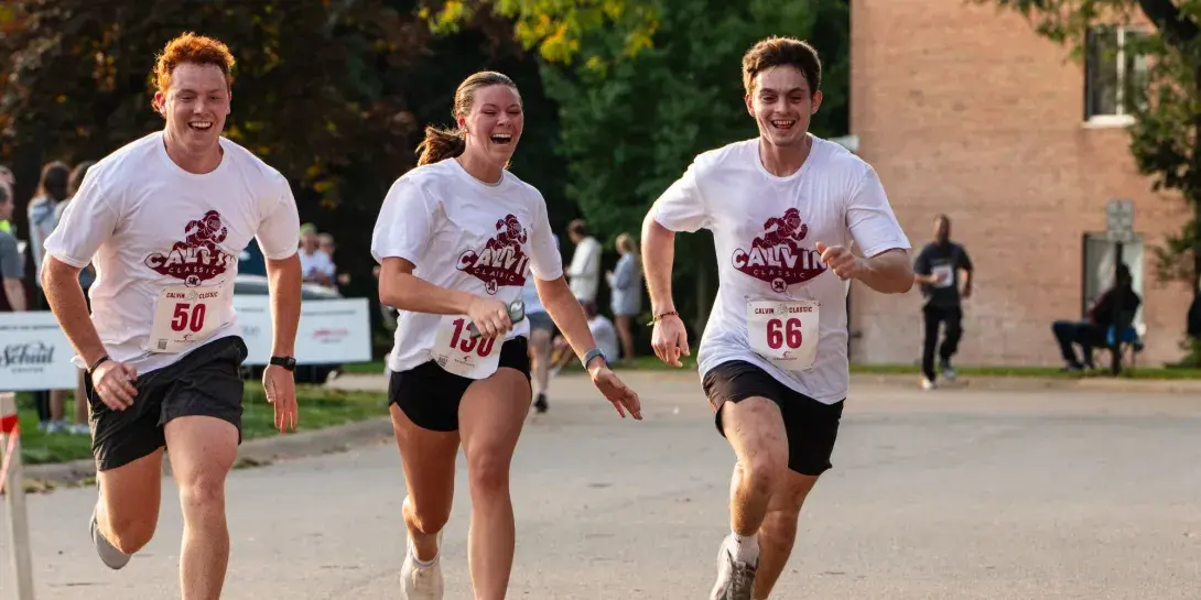 Three students running during the Calvin Classic 5K 