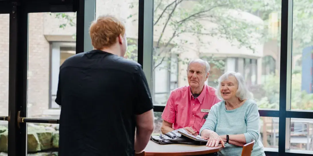 A student interacts with residents of Holland Home