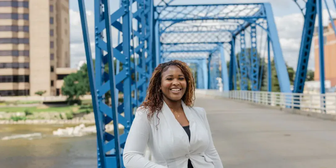 Noro Dung poses on the blue bridge in Grand Rapids.