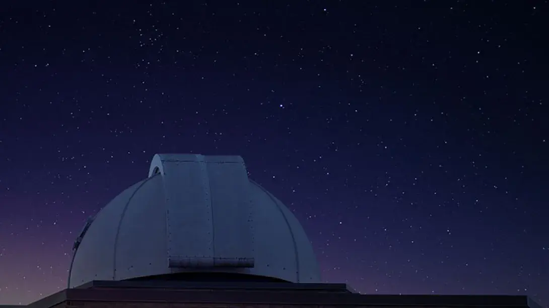 Image of the top of the Calvin Observatory with the night sky in the background