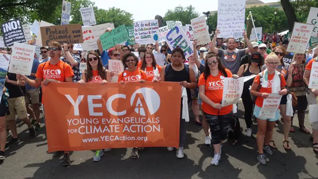 Young people carry a banner that reads "Young Evangelicals for Climate Action" through Wash. D.C.