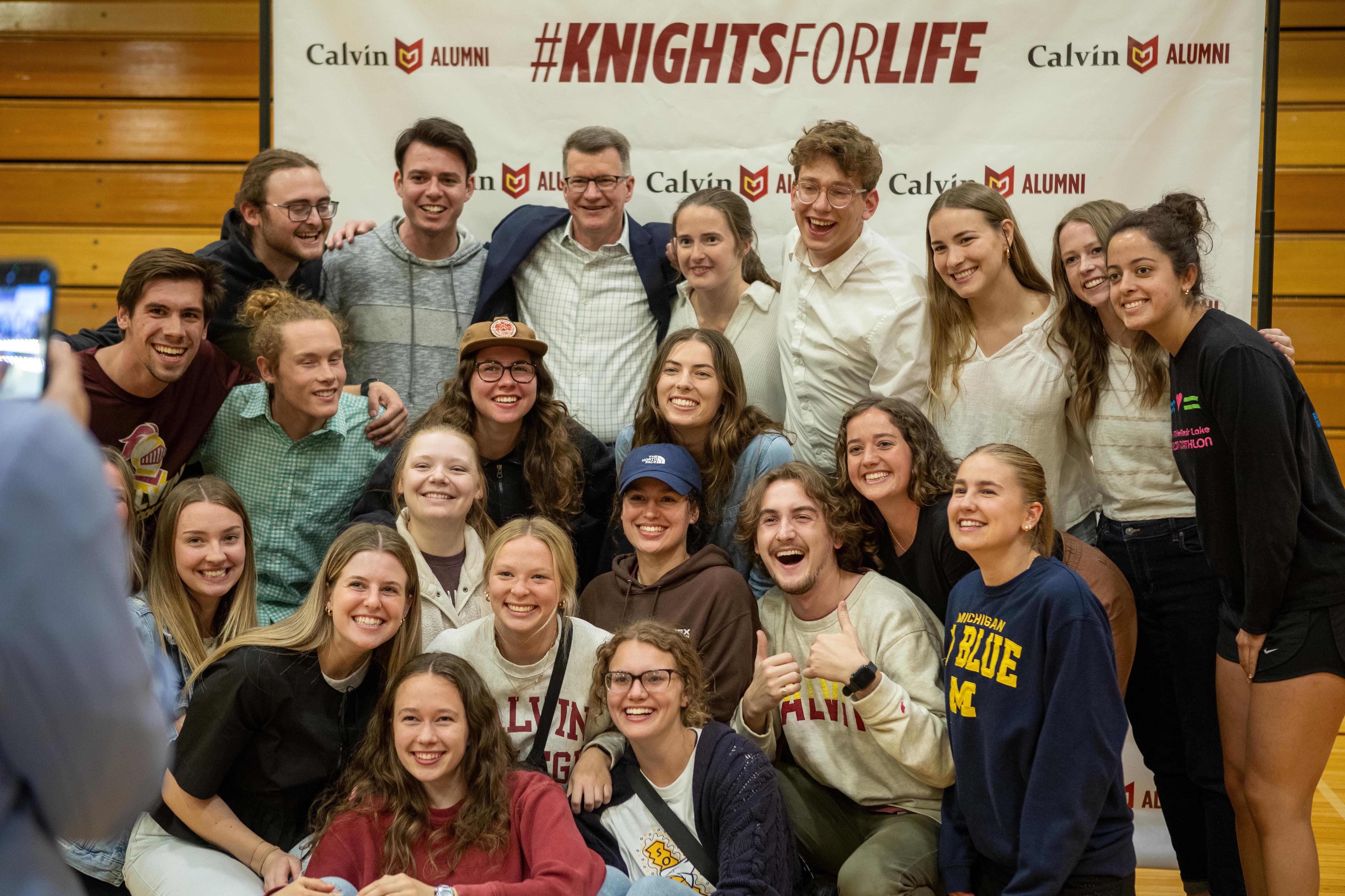 Students posed for a picture in front of a Knights For Life banner